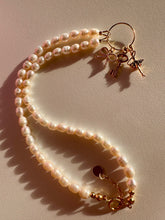 Load image into Gallery viewer, Woman pearls necklace with gold plated elements such as: round connector, bow pendant, ballerina pendant and key pendant.