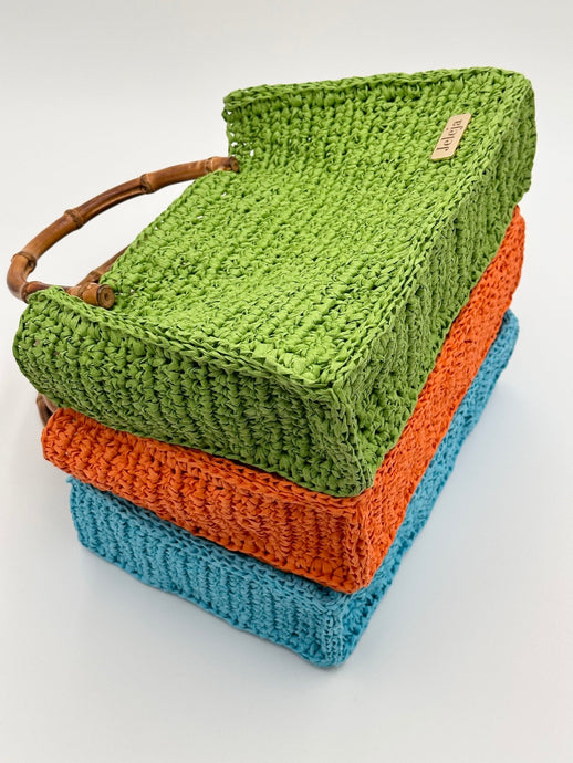 Natural raffia bags with bamboo handles. From the top: green, orange, turquoise 
